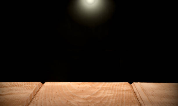 istock Wood desk black background 1292988003