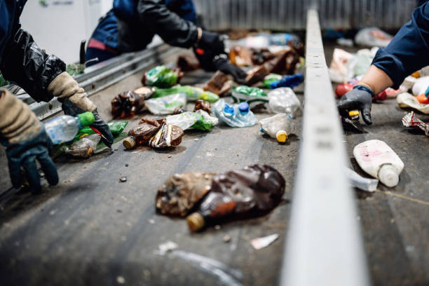 istock Manual waste bulkhead. Waste sorting plant conveyors filled with various household waste 1292988679