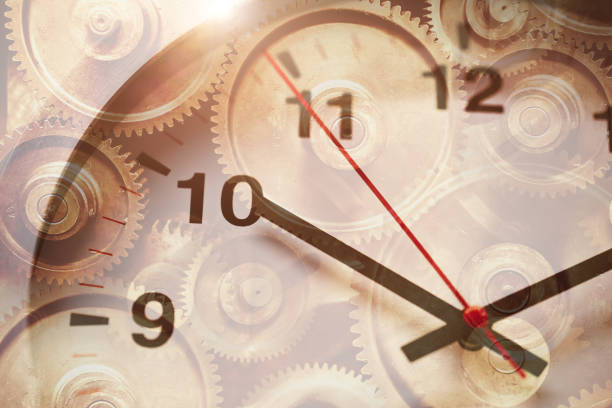 istock Time clock face overlay with gear rotation for working hours drives the business industry forward concept. 1292991663