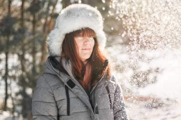 istock Young woman stands in winter forest. 1292991856