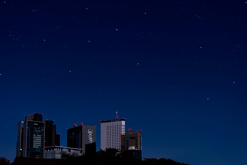 Lots of stars shining in the sky of the skyscrapers with copy space.