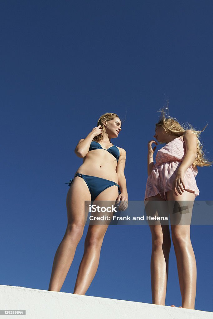 Women standing on wall outdoors  14-15 Years Stock Photo