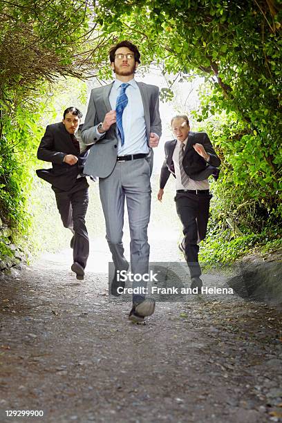 Businessmen Running On Rural Road Stock Photo - Download Image Now - Running, Chasing, Men