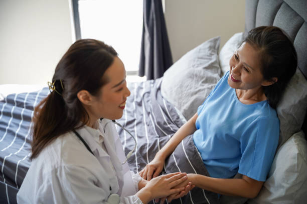 istock Female doctor consoling senior woman during a home visit 1293000310