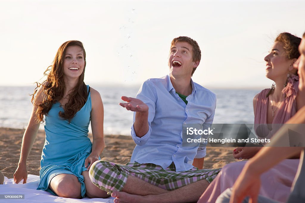 People relaxing together on beach  Beach Stock Photo