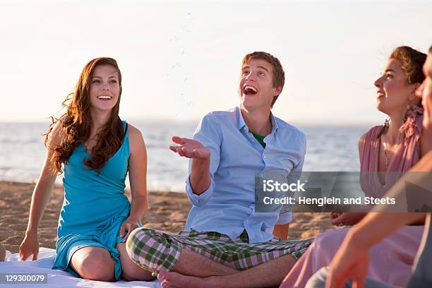 People Relaxing Together On Beach Stock Photo - Download Image Now - Beach, Friendship, Surprise
