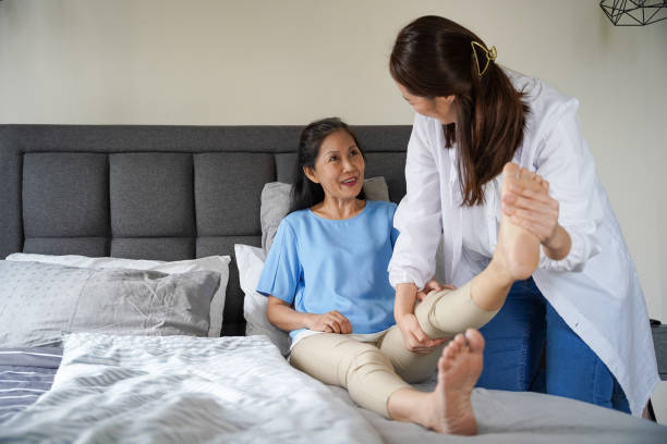 istock Patient doing physical exercises with her therapist at home 1293001784
