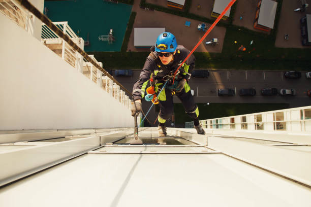 istock Industrial mountaineering worker hangs over residential building while washing exterior facade glazing 1293002421
