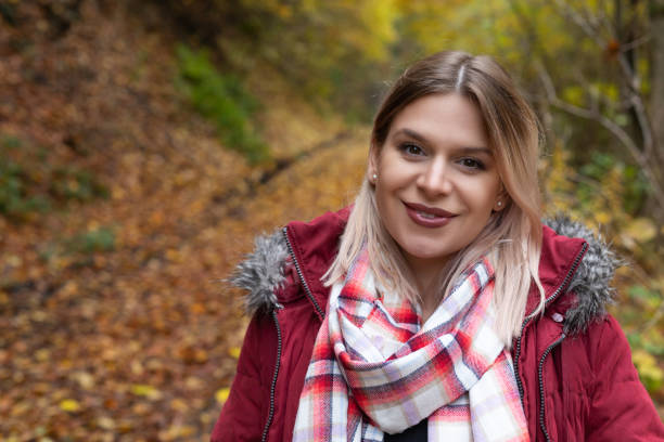 istock Woman in the park, autumnal background 1293004802