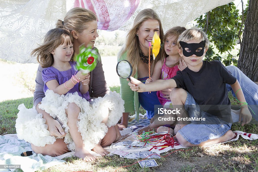 Mothers and children playing in backyard  Pinwheel Toy Stock Photo