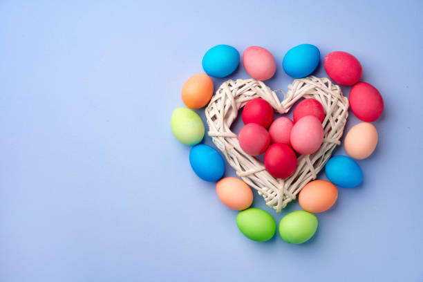 istock Colorful Easter eggs in decorative nest on blue background 1293012161