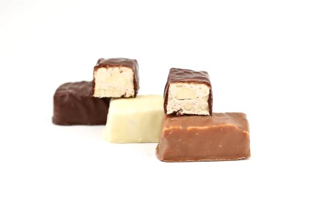 istock Small italian Torrone, or nougats, covered with milk, dark and white chocolate 1293013805