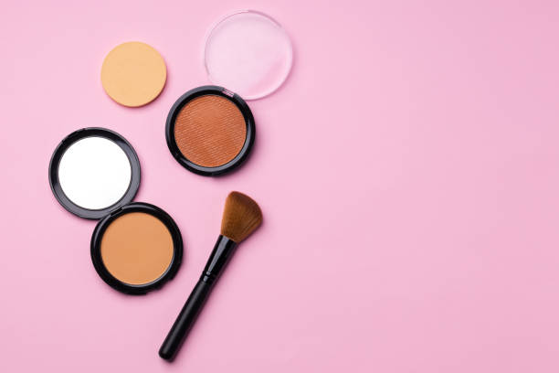istock Decorative cosmetics face powder and brush close up 1293013813