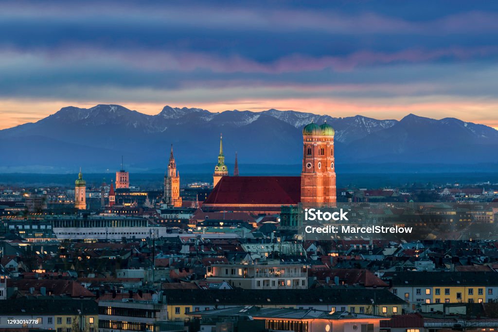 Munich at dusk - Mountains of German Alps behind Frauenkirche Munich Stock Photo