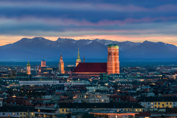 Munich at dusk - Mountains of German Alps behind Frauenkirche Munich at dusk - Mountains of German Alps behind Frauenkirche bavarian alps photos stock pictures, royalty-free photos & images