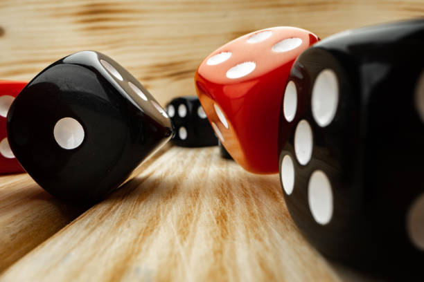 istock Red and black dice cubes on wooden background 1293015475
