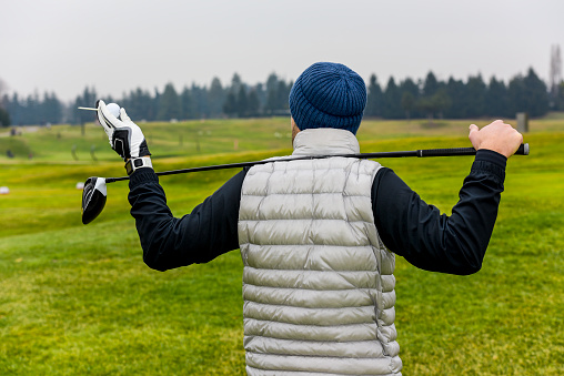 Close up of golf player with drive in hand at a golf course