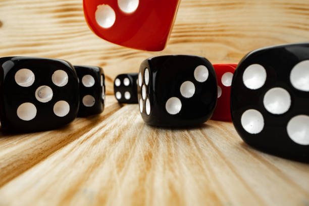 istock Red and black dice cubes on wooden background 1293015679