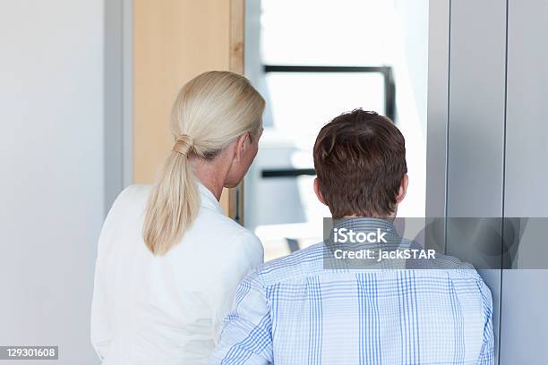 Business People Standing In Office Stock Photo - Download Image Now - Businessman, Suspicion, 30-39 Years