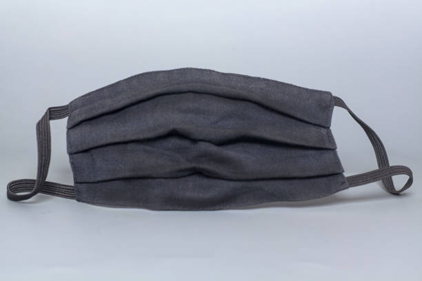 istock Black medical protective mask on grey background 1293016352