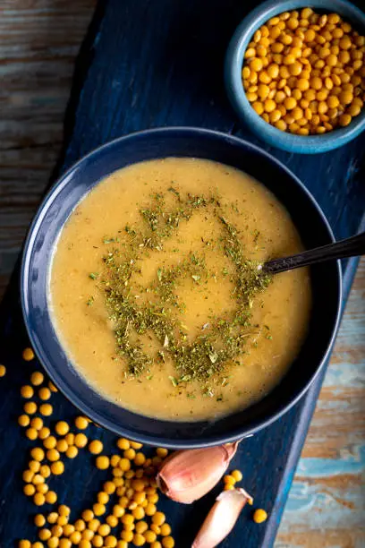 Cream soup of yellow lentils. Traditional yellow lentil soup with vegetable in bowl.