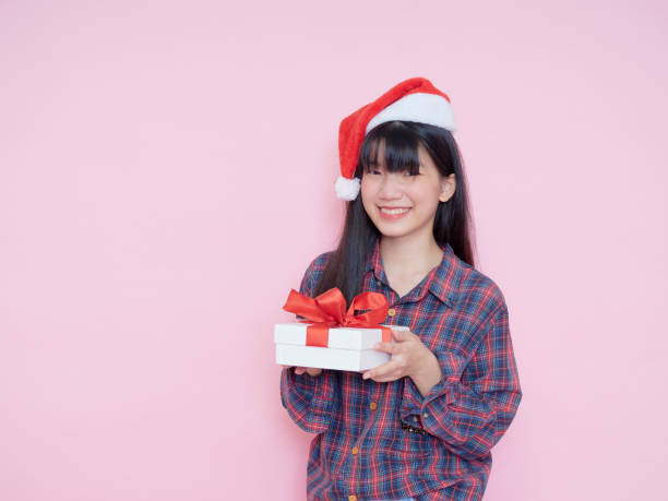 istock Cute girl holding white present boxes with red ribbon 1293016602