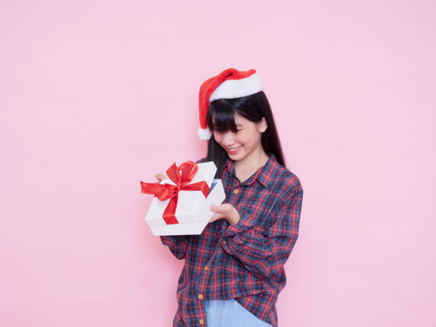 istock Cute girl holding white present boxes with red ribbon 1293016608