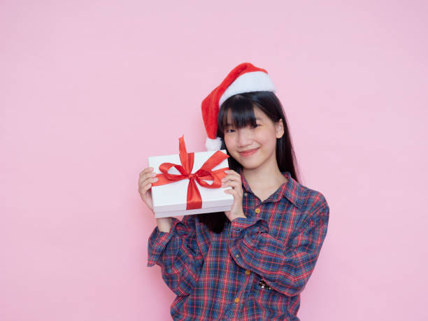 istock Cute girl holding white present boxes with red ribbon 1293016634