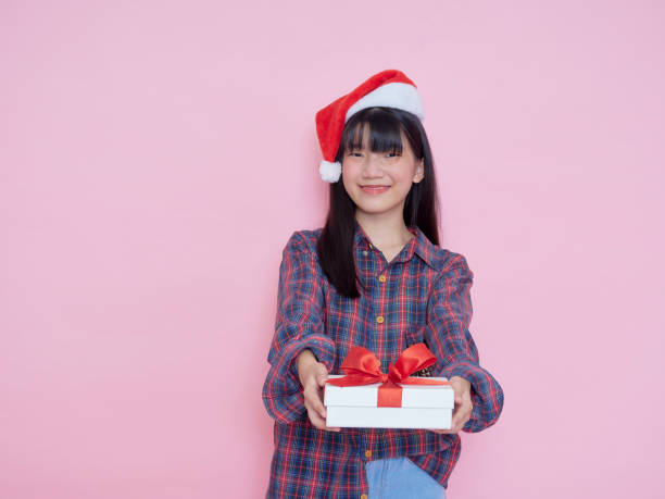 istock Cute girl holding white present boxes with red ribbon 1293016645