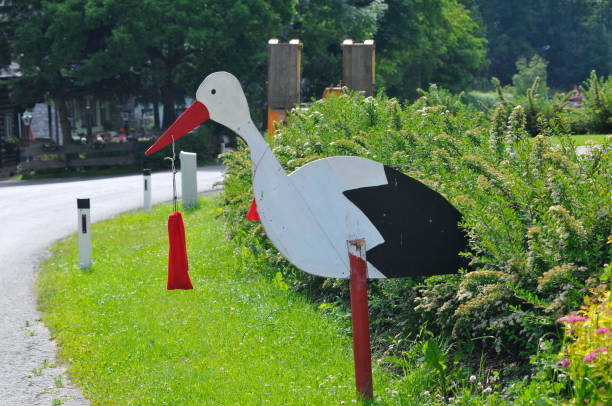 wooden rattling stork with a small bag in his beak, symbol for birth of babies