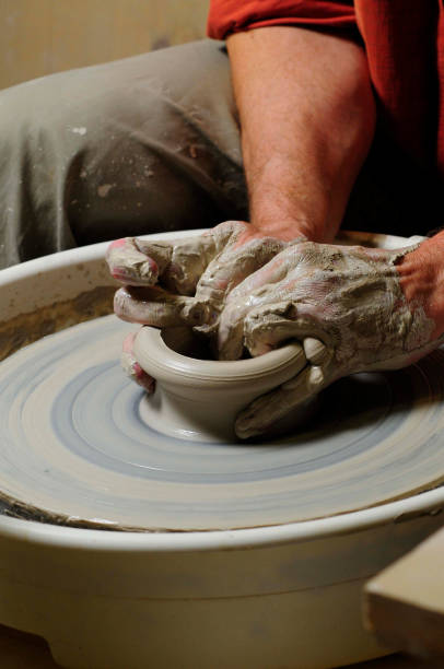 istock making pottery with hand on pottery wheel 1293017690