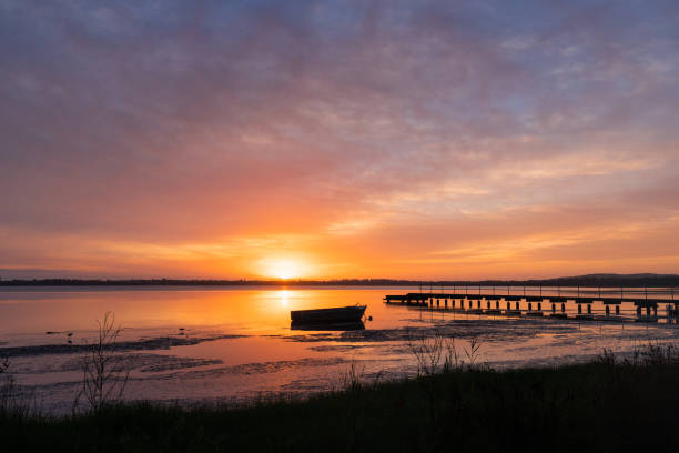 istock Boat and jetty sunrise 1293021288