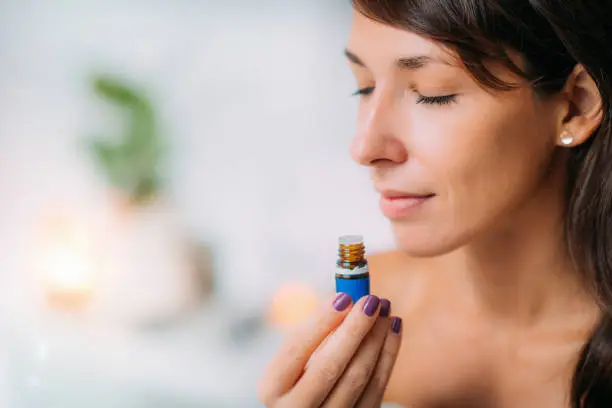 Photo of Holding and Smelling Ayurvedic Oil