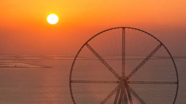 Bluewaters island at sunset aerial timelapse with ferris wheel, new walking area with shopping mall and restaurants, newly opened leisure and travel spot in Dubai