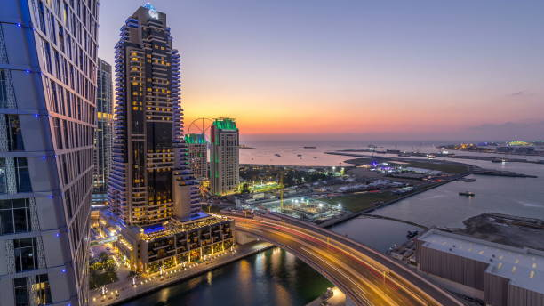 jbr and dubai marina after sunset aerial day to night timelapse - day to sunset imagens e fotografias de stock