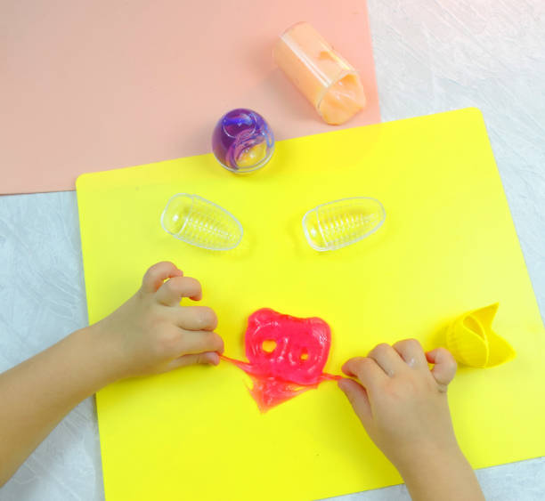 istock colored slimes , mucus ,  child plays with slimes 1293027706
