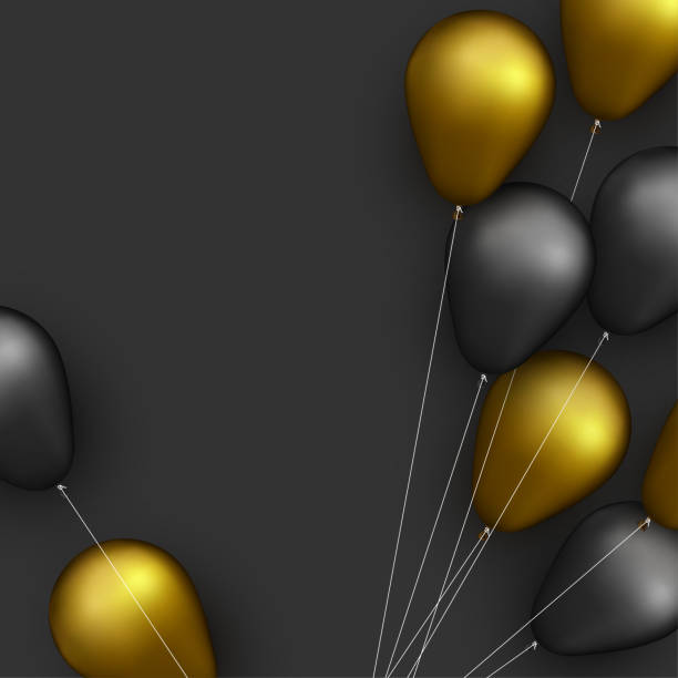 istock Black and golden foil balloons with threads on black background. 1293028020