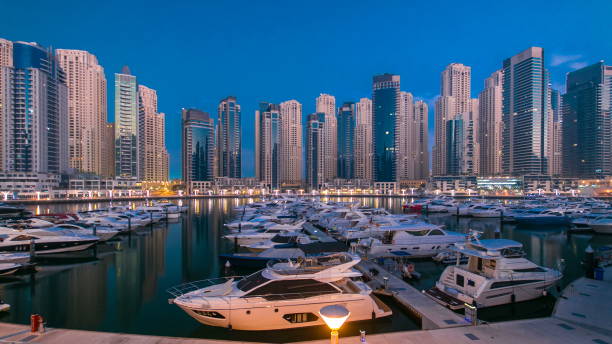 istock Dubai Marina at Blue hour night to day timelapse with yachts 1293030254