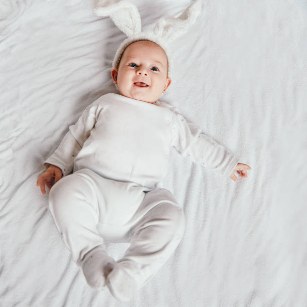 istock cute smiling baby lying on the bed 1293033520