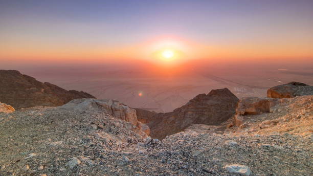 istock Sunset with rocks timelapse. Jebel Hafeet is a mountain located primarily in the environs of Al Ain and offers an impressive view over the city 1293035652