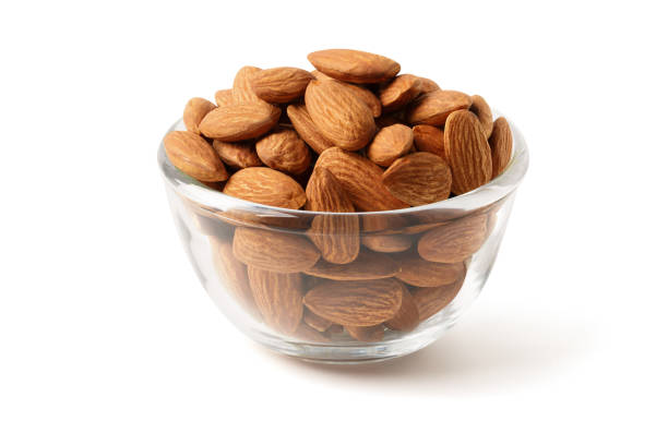 istock Almond in a clear cup on the white background with clipping path 1293038692