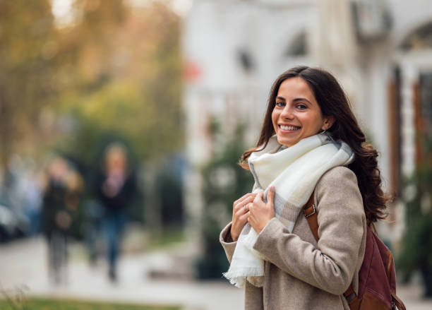 istock Young lady, wearing coat and scarf, having backpack. 1293038895