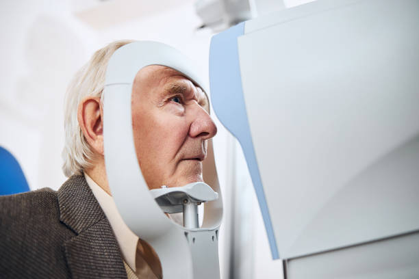 istock Gray-haired senior man undergoing the eye examination 1293039025