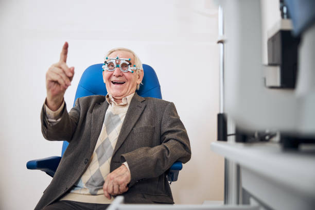 Man with a trial frame smiling at the camera