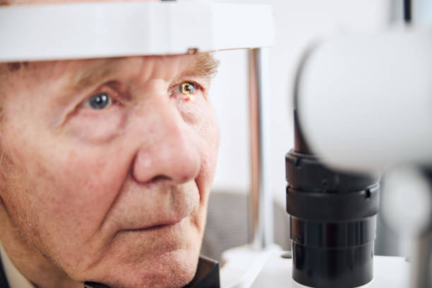 istock Serious male pensioner undergoing the eye examination 1293039038