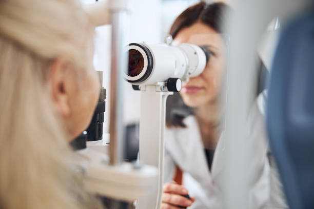 istock Doctor testing her patient eyesight with the ophthalmic equipment 1293039045