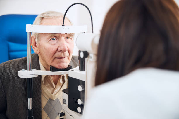 istock Experienced doctor conducting the pensioner vision screening 1293039049