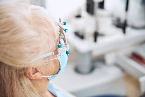 istock Blonde lady in a face mask at the ophthalmology office 1293039057