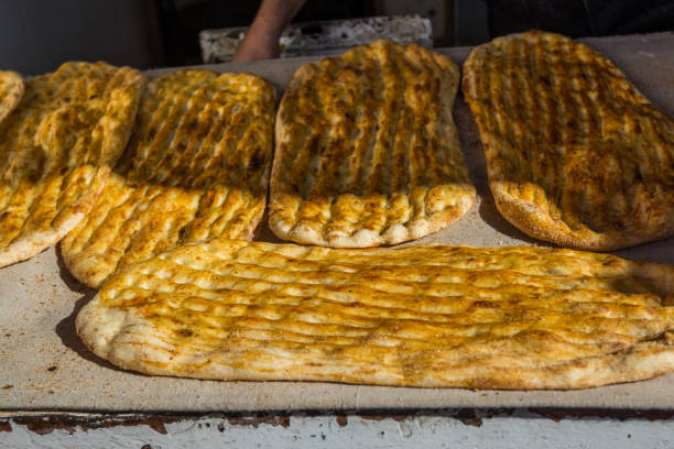 Yellow baked Barbari bread,one of the thickest flat breads,  on the food stall in Shirazi, Iran stock photo
