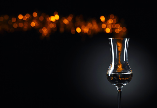 Snifter of brandy with space for text. Black background.